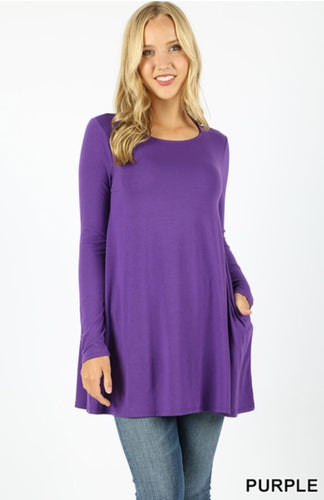 A premium fabric, long sleeve boat neck, flared top with side pockets.  Perfect with any printed leggings!
