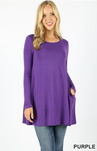 A premium fabric, long sleeve boat neck, flared top with side pockets.  Perfect with any printed leggings!